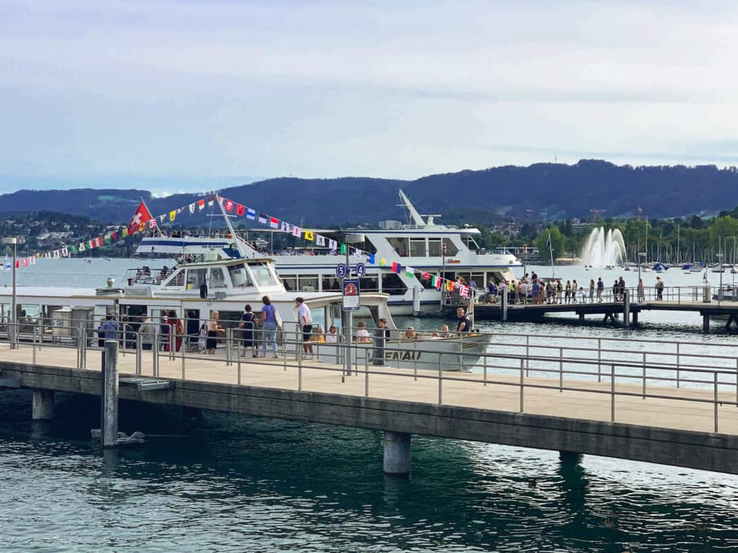 Boats on Lake Zurich with passengers queuing to get on