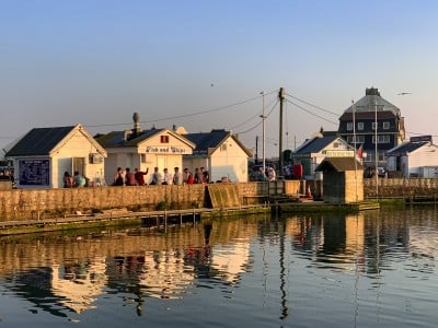 Part of the harbour in West Bay Dorset with its beach huts