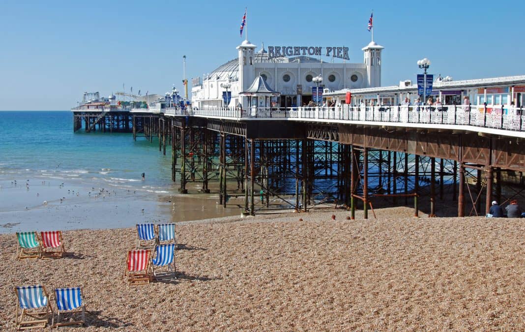 Brighton Pier with the beach and deckchairs in front