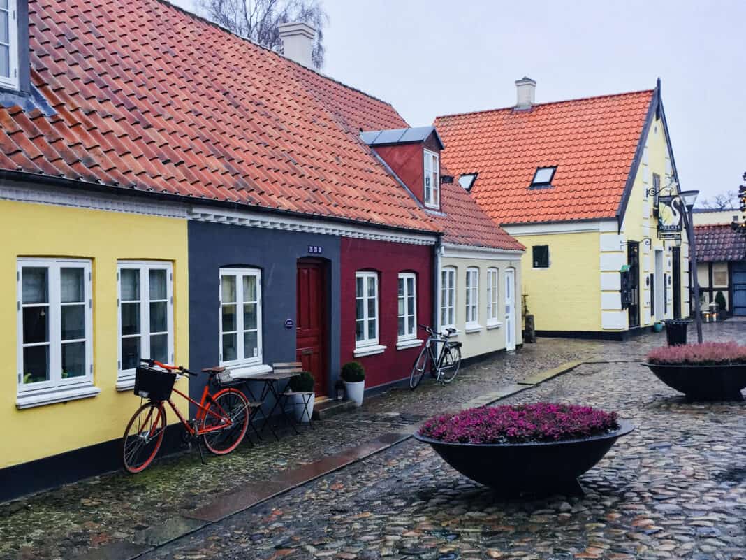 Some of the coloured buildings in Odense with bikes outside