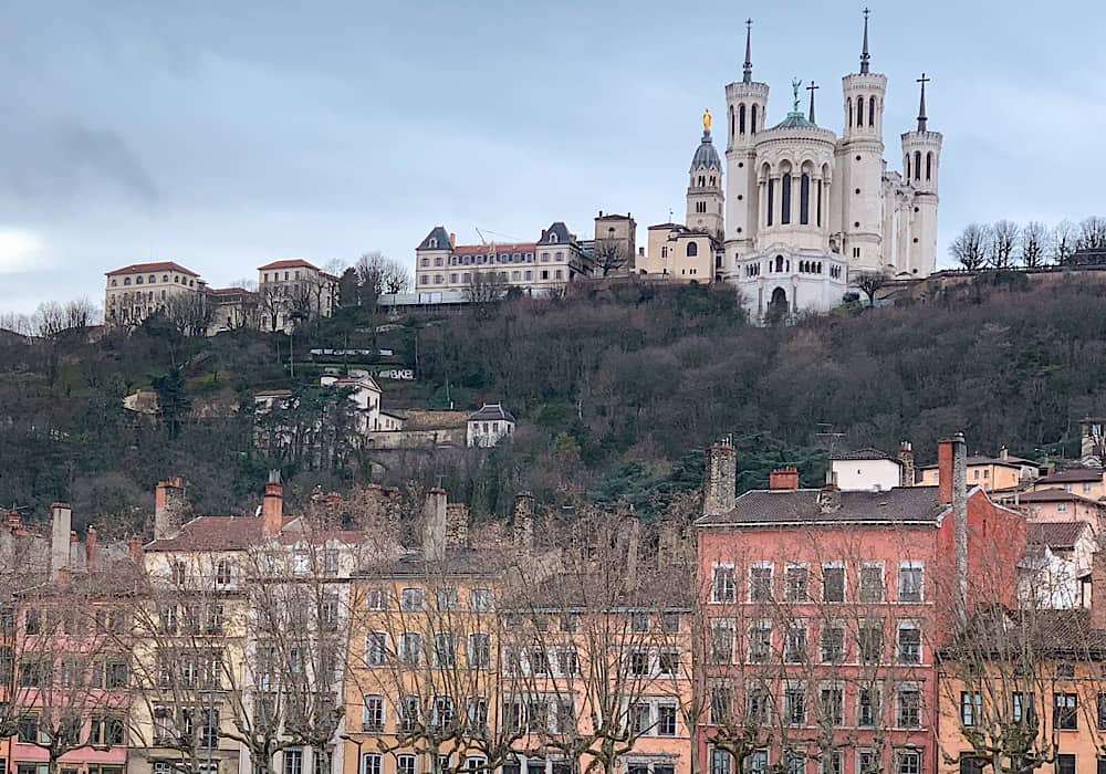 A view of Vieux Lyon the river.  You can see the colourful buildings and the basilica high on the hill