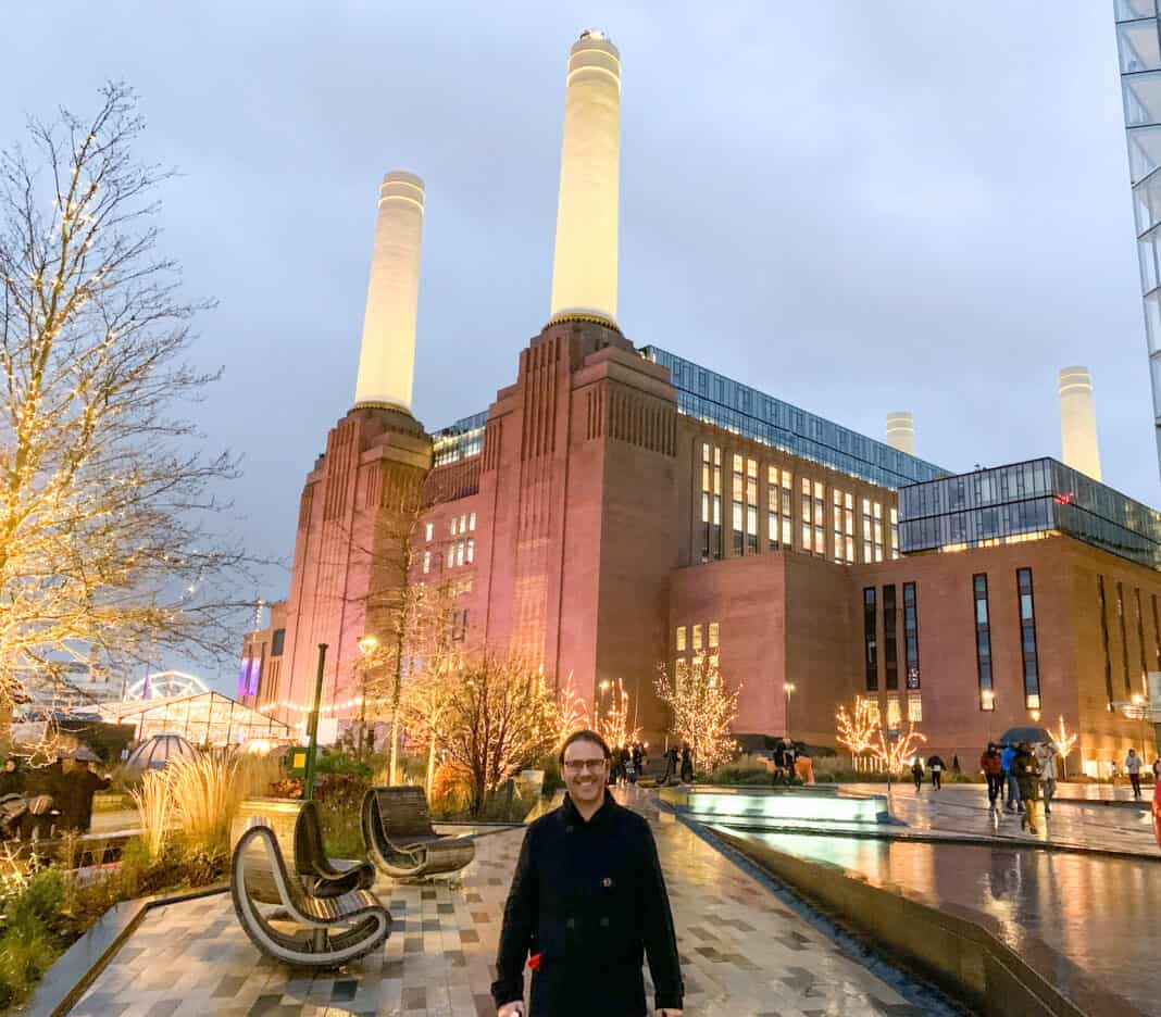 My partner standing outside Battersea Power Station at Christmas