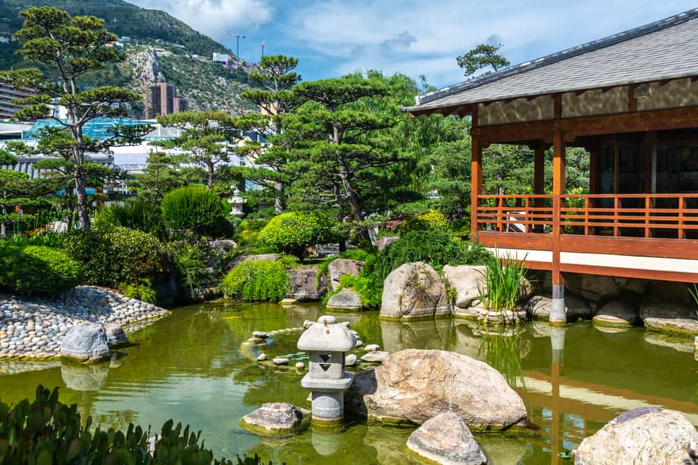 The Japanese Garden in Monaco with a lake, trees and a tea house