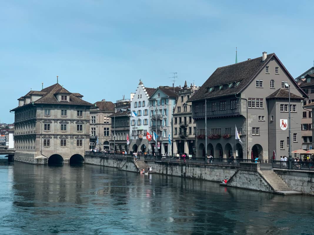 A view of the river in Zurich with the rathaus over the water