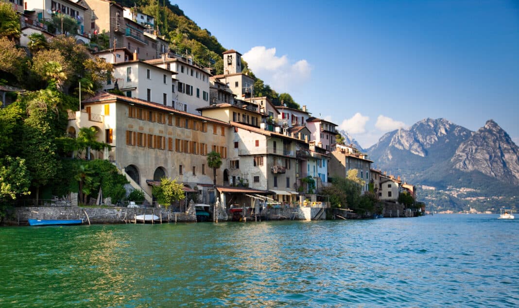 Waterside houses in Gandria with a mountain in the background - visit this place on a day trip to Lugano