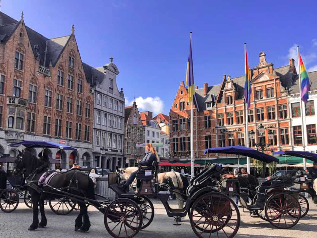 Horse drawn carriages in Bruges - taking a ride on one of these is one of the things to do on a weekend in Bruges