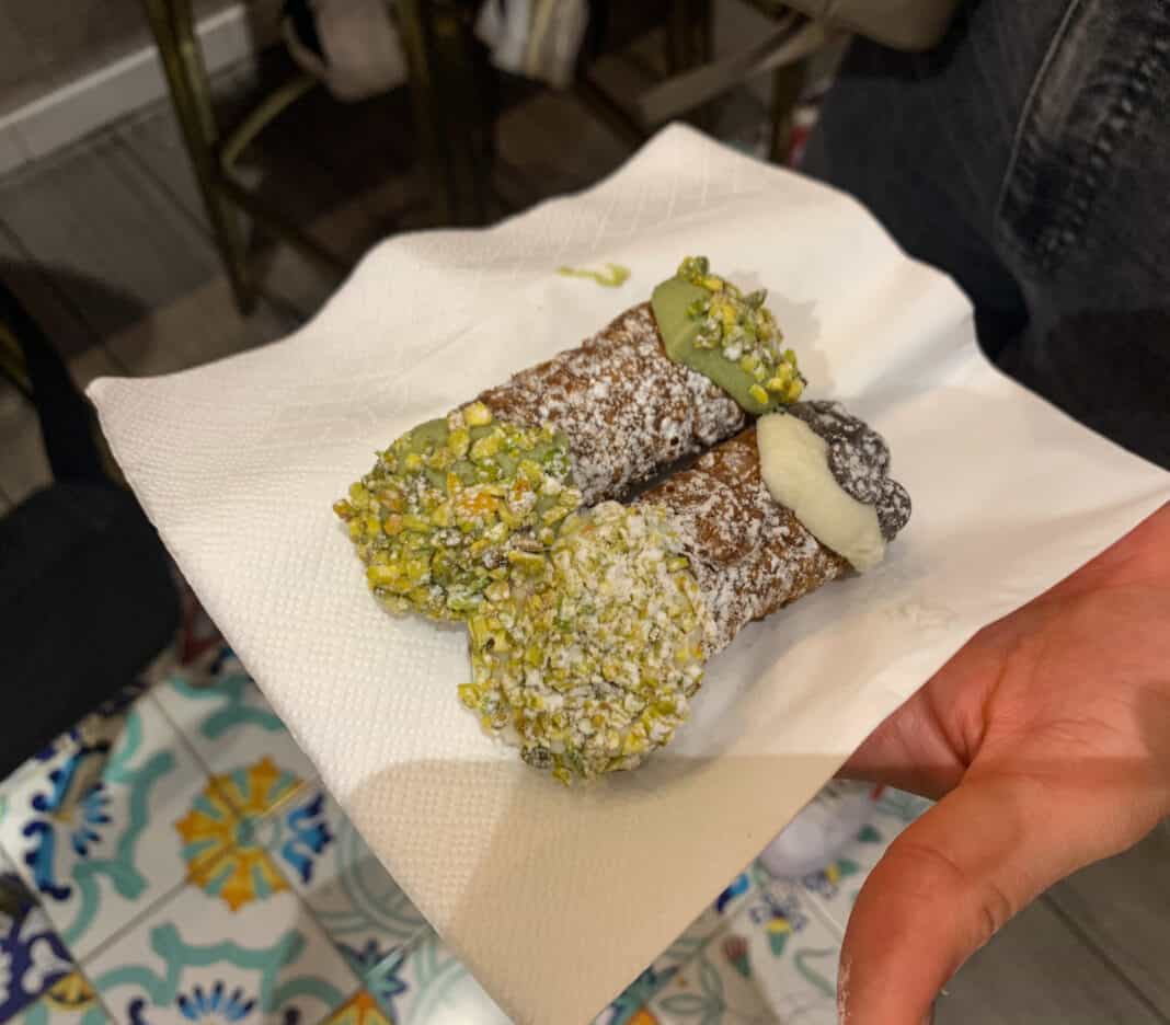 2 cannolis on the napkin - pistachio flavour. Try these on 2 days in Milan