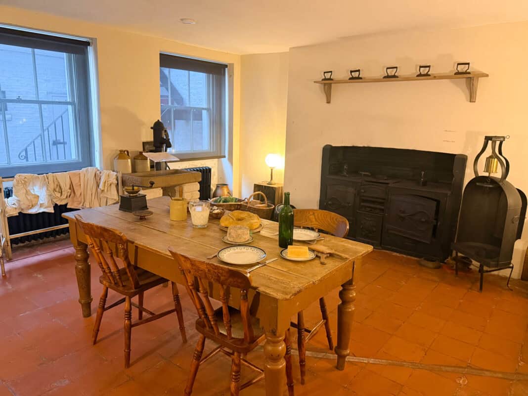Part of the basement in the Dickens House Museum in London with a table laid for a simple meal