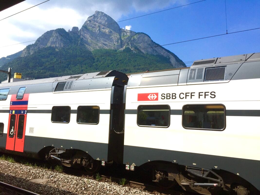 An SBB train in front of a mountai peak