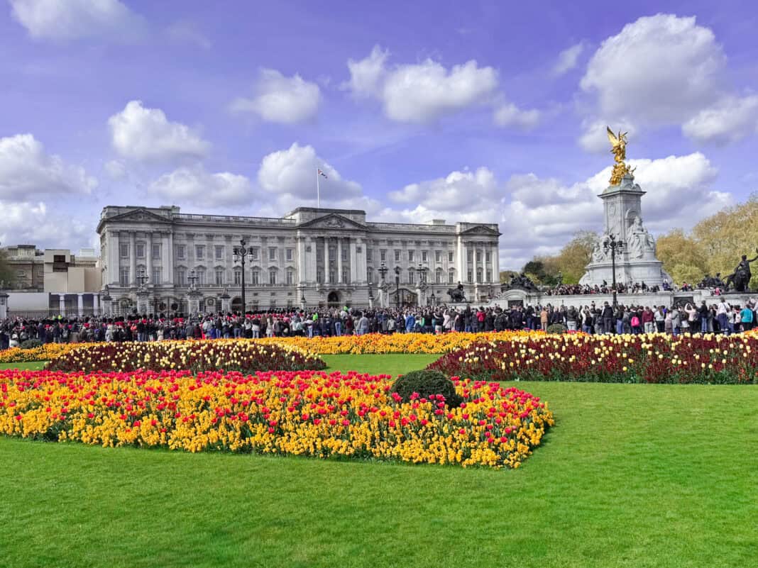 A view of Buckingham Palace with a statue and flower beds in front - see this on 3 days in London