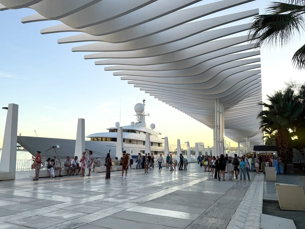 Part of the Muelle Uno port area with a large cruise ship in the background